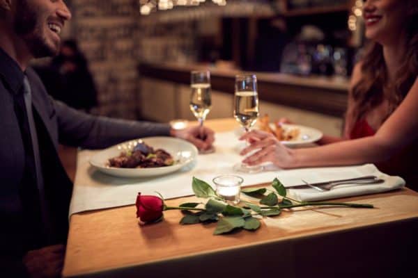 Couple-at-valentines-dinner-with-rose